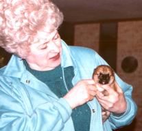 Jane Vanderpool and a tiny Shiba puppy that hasn't opened it's eyes yet.